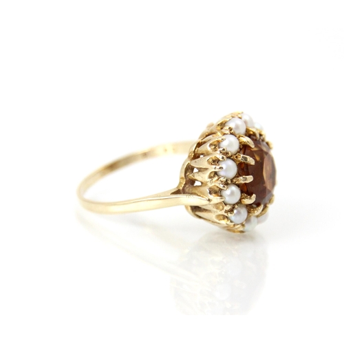 264 - A late 20th century citrine and cultured pearl cluster ring, the central round cut citrine within a ... 