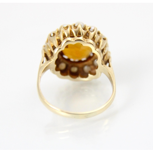 264 - A late 20th century citrine and cultured pearl cluster ring, the central round cut citrine within a ... 