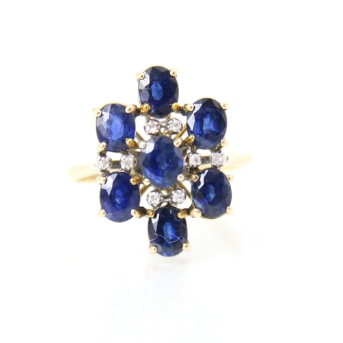 265 - A continental sapphire and diamond dress ring, the seven round cut sapphires with diamond chip highl... 