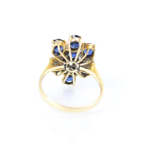 265 - A continental sapphire and diamond dress ring, the seven round cut sapphires with diamond chip highl... 