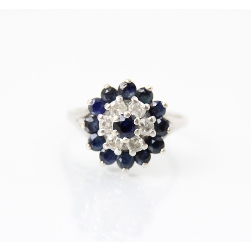 266 - A 9ct white gold untested sapphire and white sapphire cluster dress ring, the central blue stone wit... 