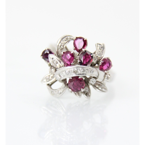 267 - A continental synthetic ruby and diamond dress ring, the raised head of the ring set with six mixed ... 