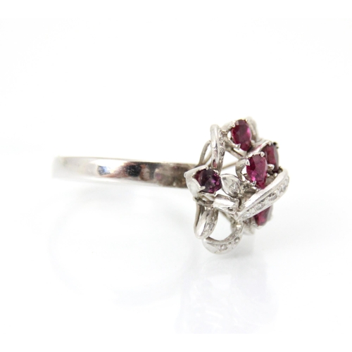 267 - A continental synthetic ruby and diamond dress ring, the raised head of the ring set with six mixed ... 