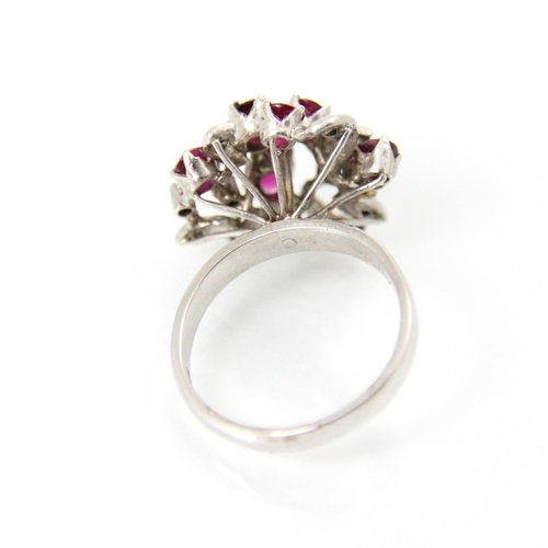 267 - A continental synthetic ruby and diamond dress ring, the raised head of the ring set with six mixed ... 