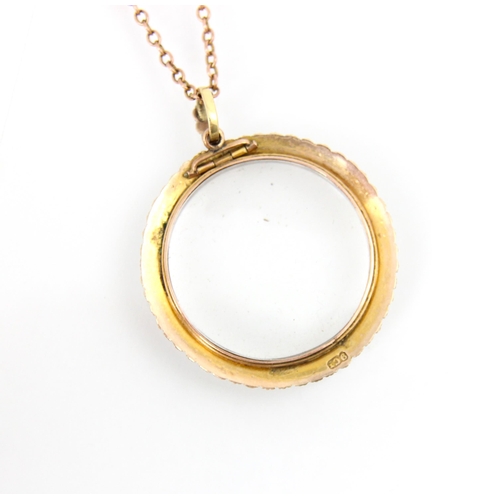 273 - A 19th century style yellow metal locket/pendant, the circular pendant with split pearl surround and... 