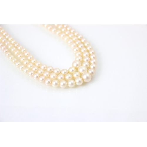 283 - A triple strand of pearls, the graduated pearls of non uniform form, upon an associated marcasite se... 