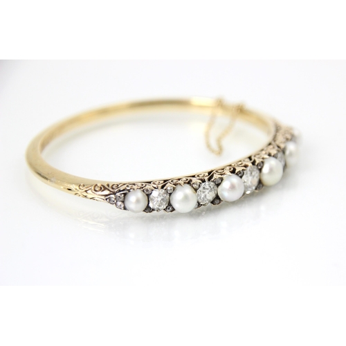 286 - An early 20th century diamond and pearl set bangle, the five old cut diamonds interspersed with rose... 