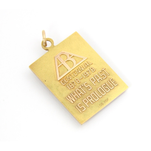 292 - A yellow metal ‘Centennial’ ingot pendant, the rectangular pendant with cast lettering ‘Centennial 1... 