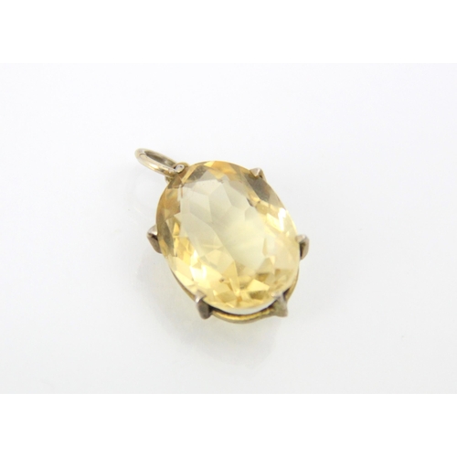 293 - A citrine set pendant, the oval cut citrine set within a claw set yellow metal mount, with a circula... 