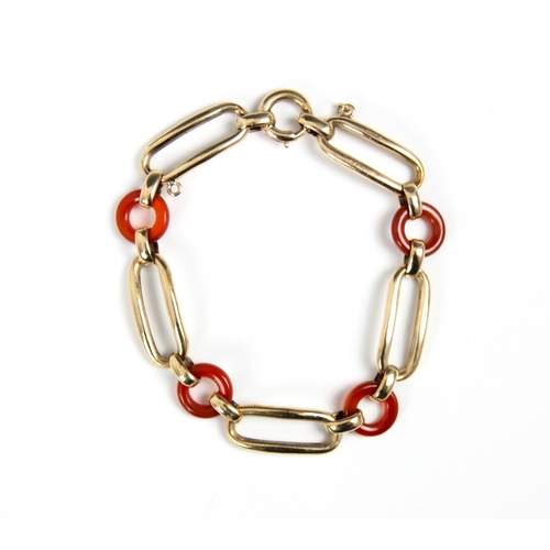 295 - An early 20th century untested carnelian and yellow metal bracelet, designed as four circular ‘dough... 