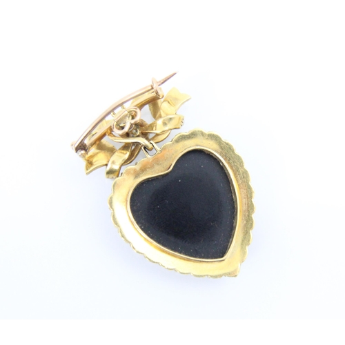 302 - A Victorian style split pearl and onyx coloured pendant/brooch, the polished heart shaped onyx colou... 