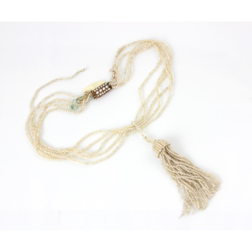 303 - A seed pearl multi strand necklace, the strands suspending a seed pearl tassel, with split pearl set... 