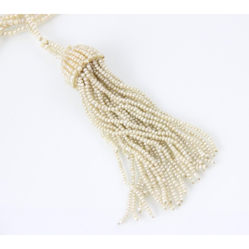 303 - A seed pearl multi strand necklace, the strands suspending a seed pearl tassel, with split pearl set... 