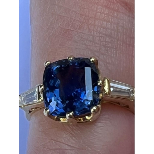 309 - An 18ct yellow gold certified sapphire and diamond three stone ring, the cushion cut sapphire (certi... 