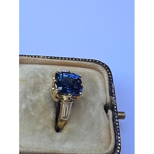 309 - An 18ct yellow gold certified sapphire and diamond three stone ring, the cushion cut sapphire (certi... 