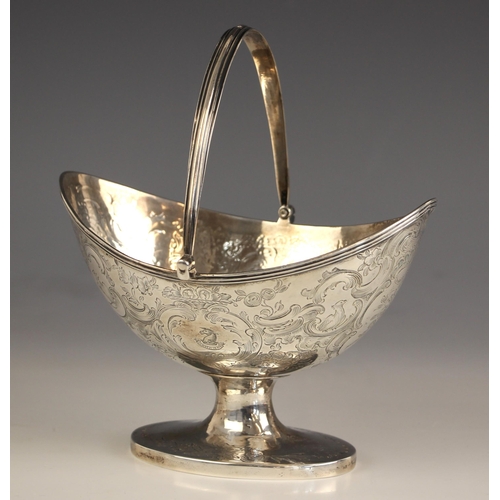 67 - A George III silver sugar basket, possibly Solomon Hougham, London 1799, the reeded swing handle abo... 