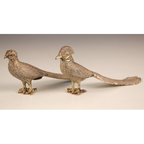 84 - A pair of sterling silver pepperettes, 20th century, modelled a cock and hen pheasant with realistic... 