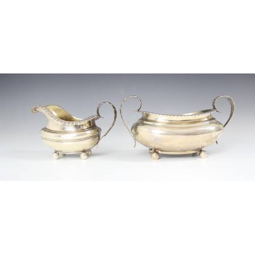 87 - A George IV silver milk jug, John James Keith, London 1828, the gadroon rim below cast leaf handle w... 