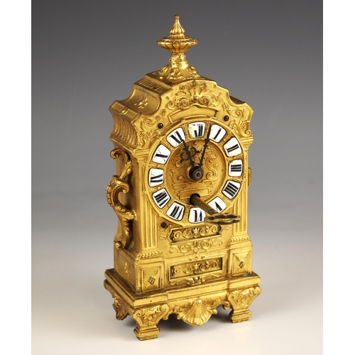 900 - A French gilt metal baroque boudoir timepiece, late 19th century, the case cast with side scroll han... 