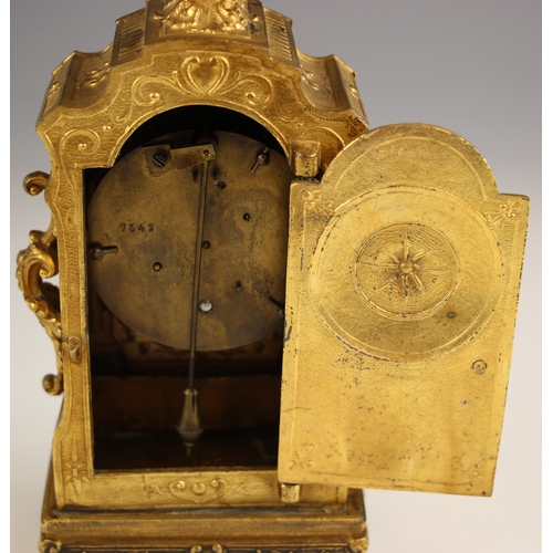 900 - A French gilt metal baroque boudoir timepiece, late 19th century, the case cast with side scroll han... 