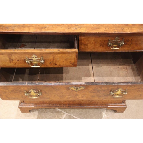 907 - A burr elm chest of drawers, early 18th century, the quarter veneered and cross banded top over an a... 