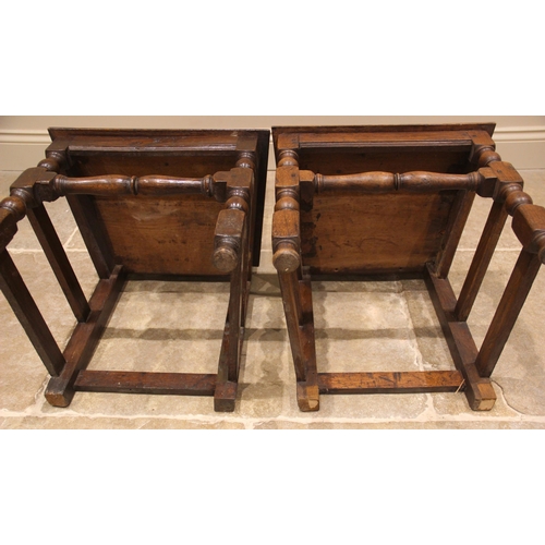 908 - A pair of 18th century oak side chairs, the vase shaped splats above a board seat, upon block and bo... 