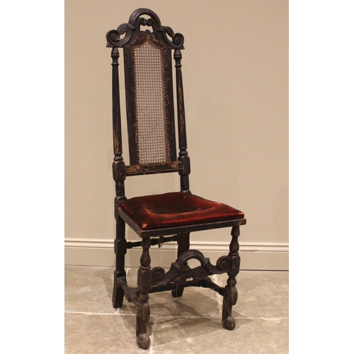 912 - A 17th century ebonised Carolean hall chair, the high back with cane work panel, upon baluster and r... 