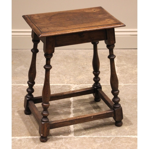 914 - An 18th century style jointed oak stool, the rectangular top upon slender baluster, bobbin turned su... 