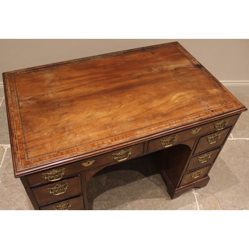 926 - A George III mahogany kneehole desk, the moulded crossbanded top above a pair of oak lined frieze dr... 