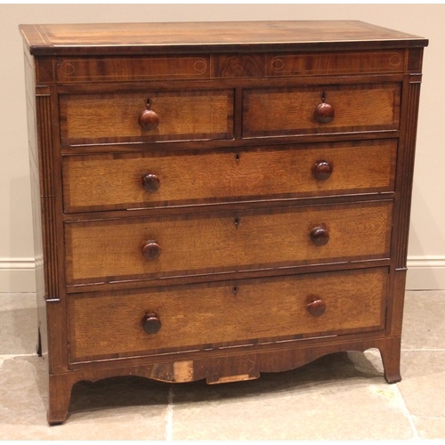 927 - A George IV oak and mahogany crossbanded chest of drawers, formed with a pair of secret frieze drawe... 