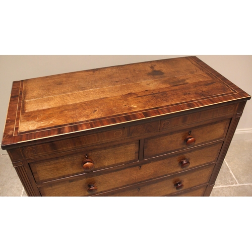 927 - A George IV oak and mahogany crossbanded chest of drawers, formed with a pair of secret frieze drawe... 