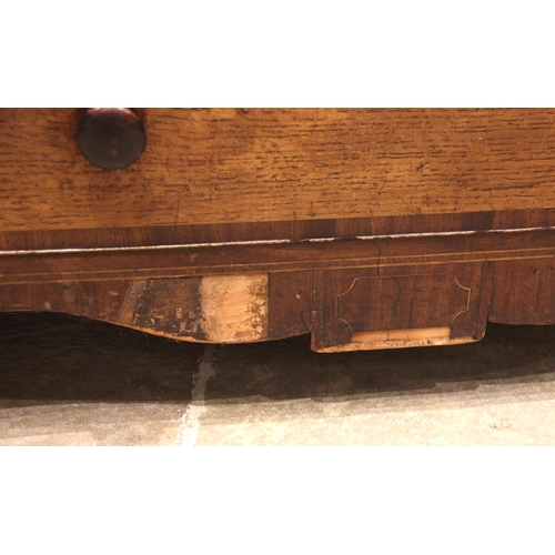 927 - A George IV oak and mahogany crossbanded chest of drawers, formed with a pair of secret frieze drawe... 