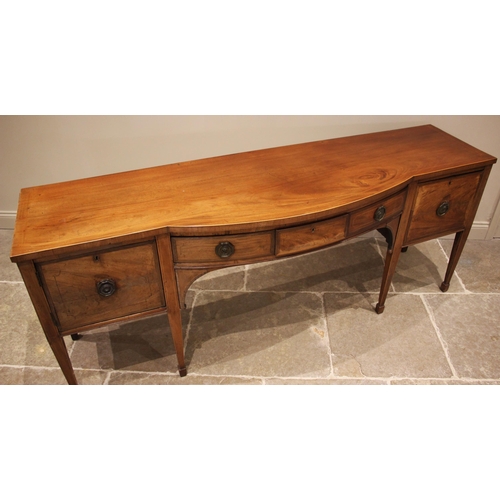 937 - A Regency mahogany sideboard, of break arch form, outlined with boxwood stringing, the central conve... 