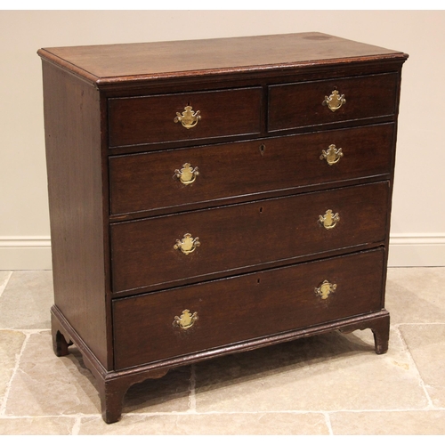 942 - A George III oak straight front chest of drawers, formed with an arrangement of two short over three... 