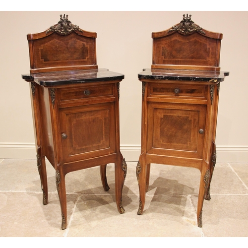 956 - A pair of Louis XV style walnut and marble topped bedside cupboards, early to mid 20th century, each... 