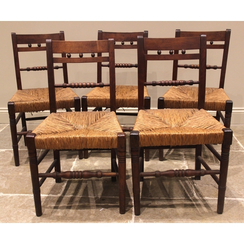 958 - A set of five Regency fruitwood country chairs, each with a bobbin turned rail back over an envelope... 