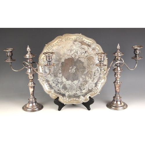 96 - A pair of silver plate candelabra, the beaded rims above urn shaped sconces, with conforming stem an... 