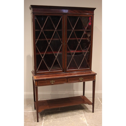 969 - A mahogany and satinwood crossbanded display cabinet on stand, 19th century, the moulded dentil corn... 