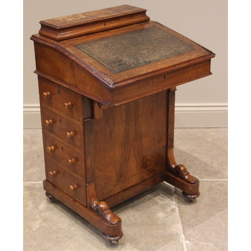 980 - A Victorian figured walnut Davenport, with a hinged stationery compartment over a leather inset skiv... 