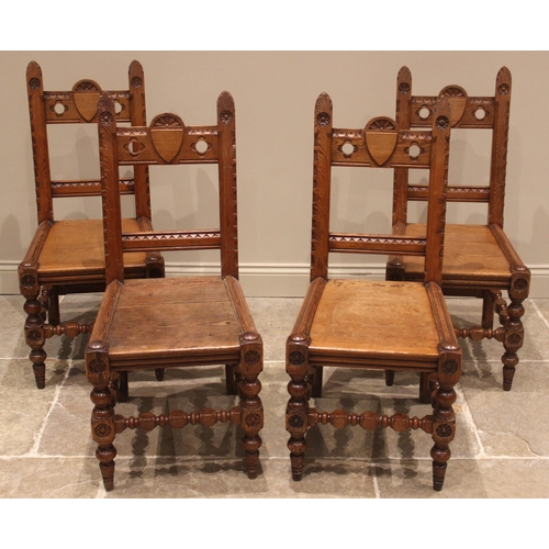 982 - A set of four pitch pine ecclesiastical hall/side chairs, late 19th/early 20th century, the rail bac... 