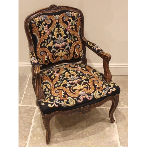 984 - A Louis XV style stained beech and tapestry upholstered fauteuil, mid 20th century, the frame carved... 