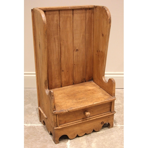 991 - A Welsh child's pine lambing chair, 19th century and later, the high back with shaped wing backs ove... 