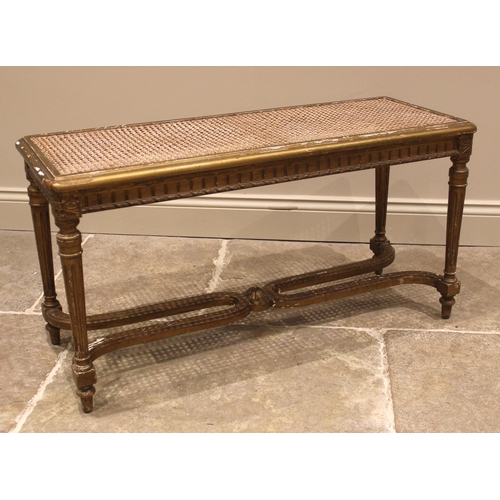 995 - A Louis XVI style giltwood and cane work window seat or stool, late 19th/early 20th century, the rec... 