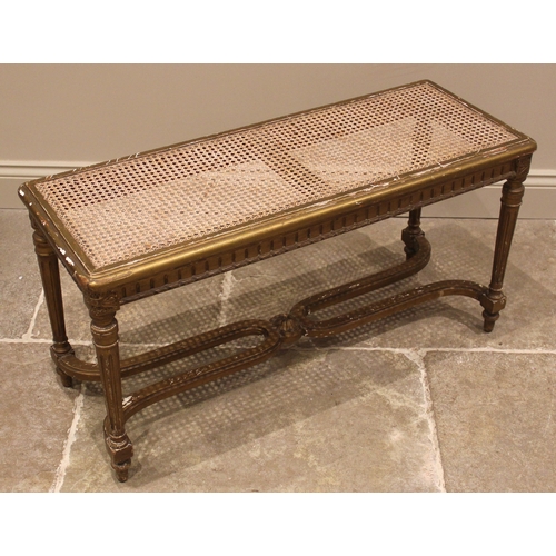 995 - A Louis XVI style giltwood and cane work window seat or stool, late 19th/early 20th century, the rec... 