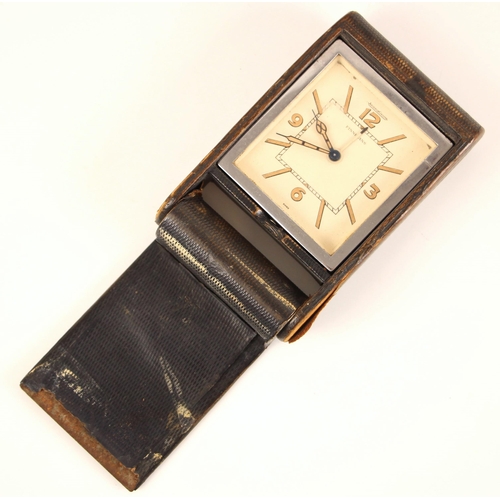 126 - A Jaeger LeCoutre travel alarm clock, the square cream dial with baton markers and Arabic numerals, ... 