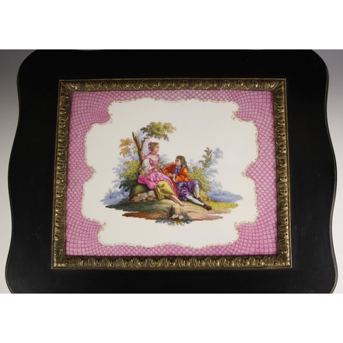 885 - A KPM tile and ebonised ladies toilet box circa 1860, the serpentine outlined hinged cover inset wit... 