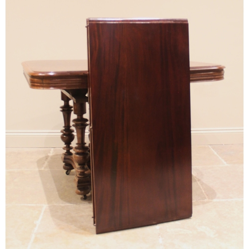 1053 - A French walnut country dining table, early 20th century, the polished rounded rectangular top raise... 