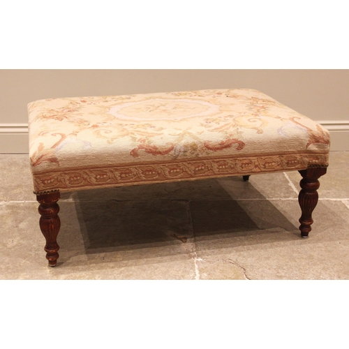 1063 - An Aubusson type tapestry upholstered footstool, late 20th century, the rectangular padded seat in f... 