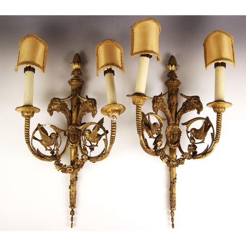 728 - A pair of giltwood and gesso Rococo style twin branch wall sconces, 19th century, the tapering centr... 