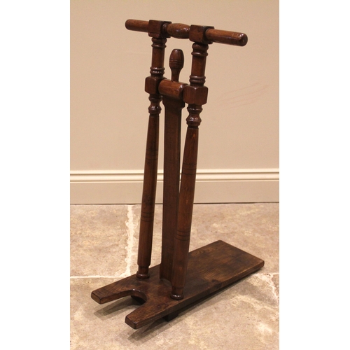 763 - An oak country house boot jack, 20th century, with ring turned and incised uprights, 82cm high
